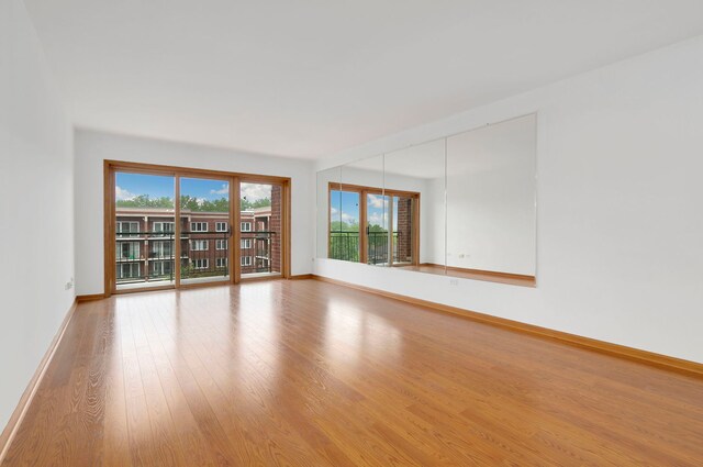 5360 N Lowell Ave Unit 502, Chicago, IL 60630 - empty room with healthy amount of natural light and wood finished floors