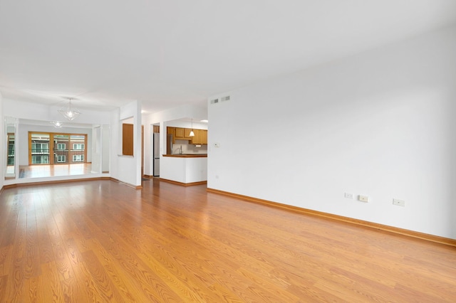 5360 N Lowell Ave Unit 502, Chicago, IL 60630 - unfurnished living room with light wood finished floors and baseboards