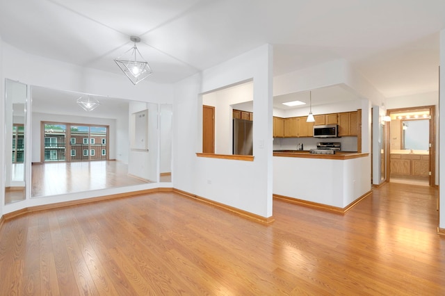 5360 N Lowell Ave Unit 502, Chicago, IL 60630 - unfurnished living room with light wood finished floors and baseboards