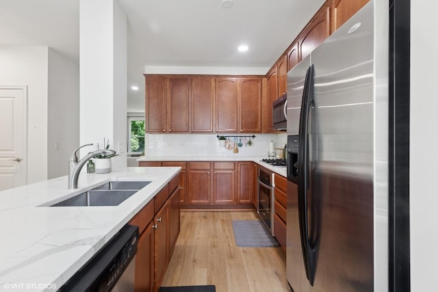 5530 Cambridge Way, Hanover Park, IL 60133 - kitchen featuring stainless steel appliances, light stone counters, light wood-type flooring, recessed lighting, and brown cabinetry