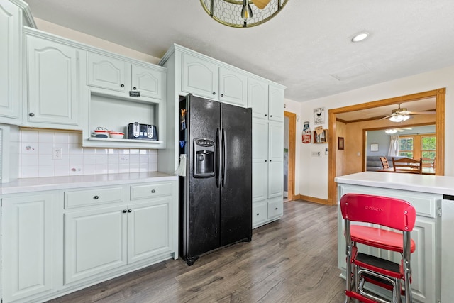 6422 Steward Rd, Rockford, IL 61101 - kitchen featuring black refrigerator with ice dispenser, wood finished floors, light countertops, a ceiling fan, and decorative backsplash