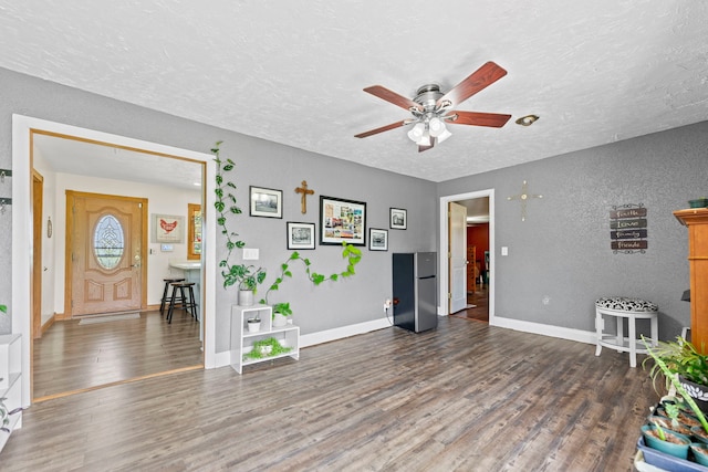 6422 Steward Rd, Rockford, IL 61101 - living area featuring a textured ceiling, wood finished floors, a textured wall, and a ceiling fan