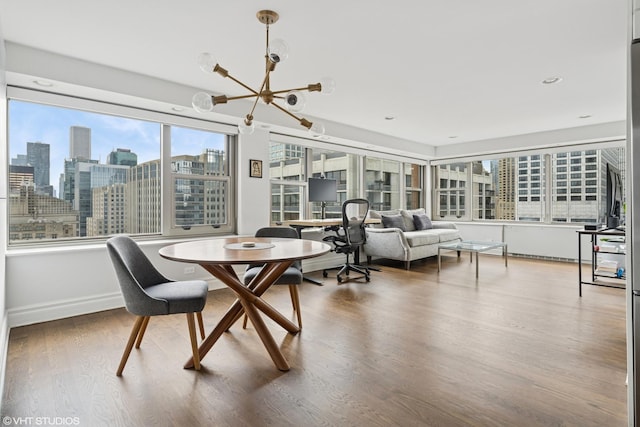 247 E Chestnut St Unit 2504, Chicago, IL 60611 - dining space with a chandelier, wood finished floors, and a view of skyline