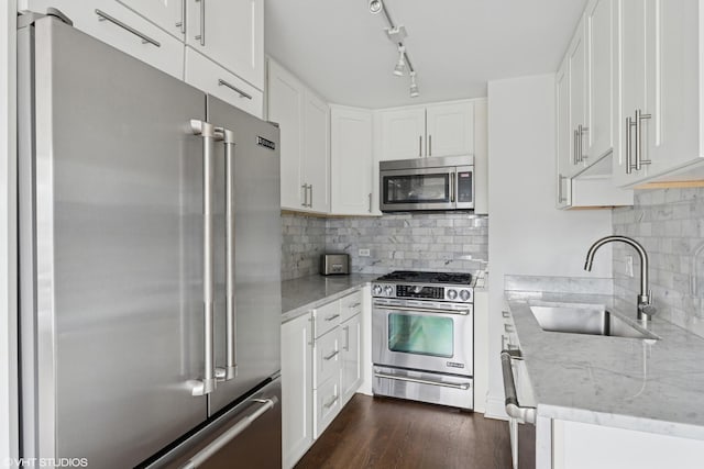 247 E Chestnut St Unit 2504, Chicago, IL 60611 - kitchen featuring stainless steel appliances, light stone countertops, decorative backsplash, and white cabinets