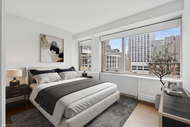 247 E Chestnut St Unit 2504, Chicago, IL 60611 - bedroom with wood finished floors and a city view