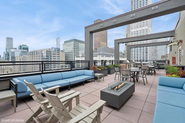 247 E Chestnut St Unit 2504, Chicago, IL 60611 - view of patio / terrace with an outdoor living space with a fire pit, a view of skyline, and outdoor dining area