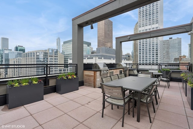 247 E Chestnut St Unit 2504, Chicago, IL 60611 - view of patio / terrace with an outdoor kitchen, a skyline view, and outdoor dining space