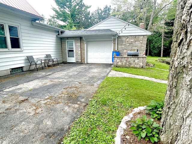 825 Swift Ave, Oglesby, IL 61348 - view of home's exterior featuring driveway, a garage, a yard, and a chimney
