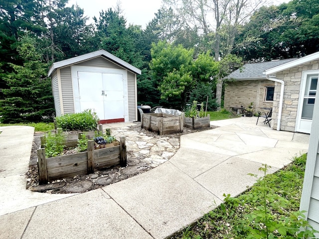 825 Swift Ave, Oglesby, IL 61348 - view of patio / terrace featuring a garden and a storage shed