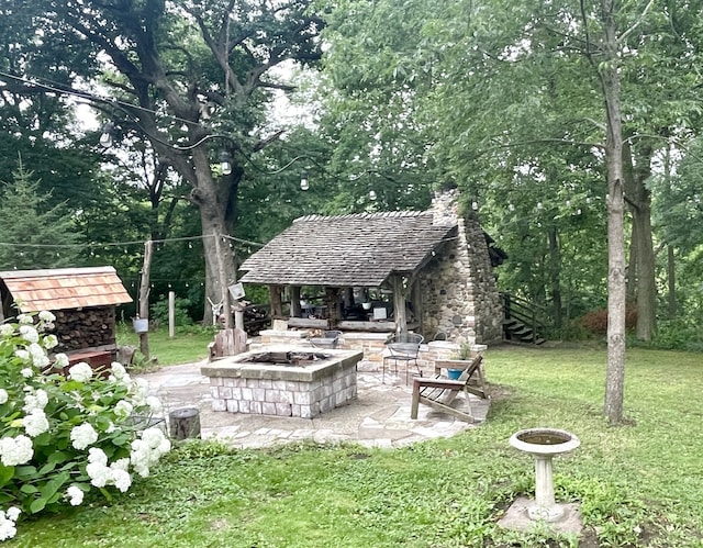 825 Swift Ave, Oglesby, IL 61348 - view of grassy yard featuring an outdoor fire pit and a patio