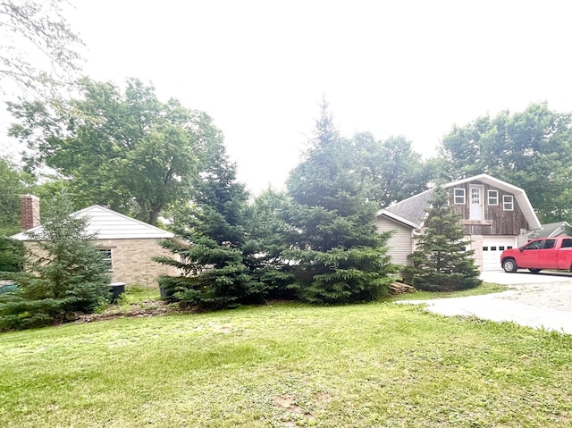 825 Swift Ave, Oglesby, IL 61348 - view of grassy yard with an attached garage and driveway
