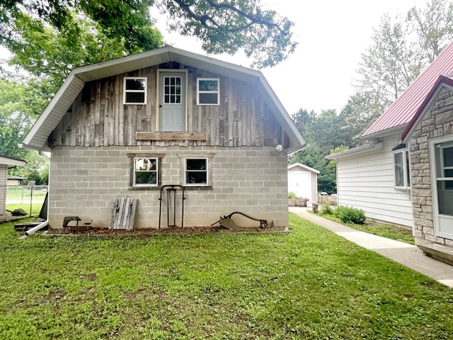 825 Swift Ave, Oglesby, IL 61348 - view of home's exterior with a yard, a metal roof, and concrete block siding