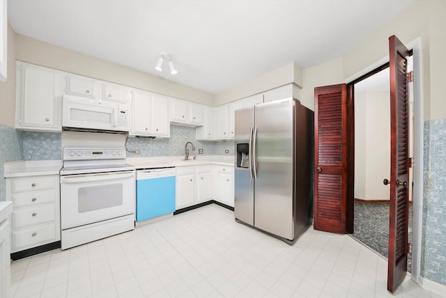 77 Lake Hinsdale Dr Unit 207, Willowbrook, IL 60527 - kitchen featuring white appliances, light countertops, white cabinets, and decorative backsplash