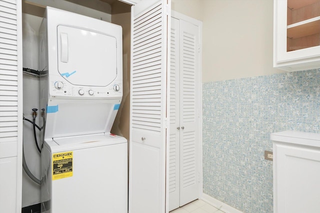 77 Lake Hinsdale Dr Unit 207, Willowbrook, IL 60527 - laundry area with stacked washer / dryer and light tile patterned floors