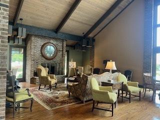 77 Lake Hinsdale Dr Unit 207, Willowbrook, IL 60527 - living area featuring a brick fireplace, wood finished floors, and wooden ceiling