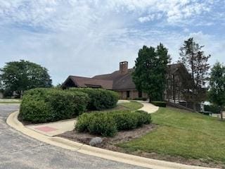 77 Lake Hinsdale Dr Unit 207, Willowbrook, IL 60527 - view of side of property featuring a yard and a chimney