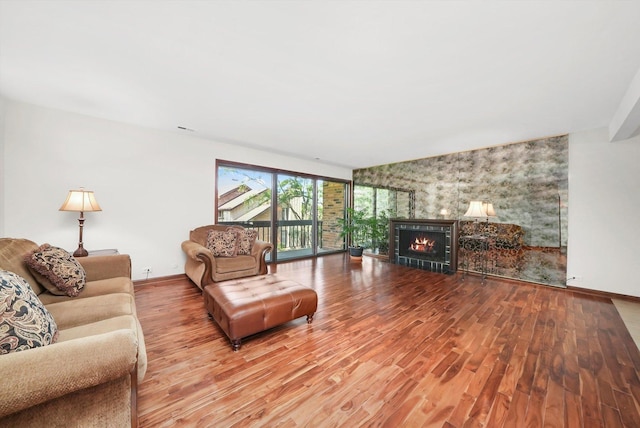 77 Lake Hinsdale Dr Unit 207, Willowbrook, IL 60527 - living room with wood finished floors, a warm lit fireplace, and an accent wall