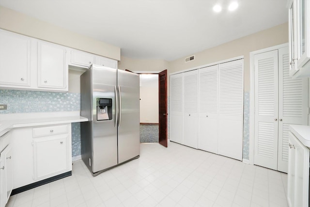 77 Lake Hinsdale Dr Unit 207, Willowbrook, IL 60527 - kitchen featuring stainless steel refrigerator with ice dispenser, light countertops, white cabinetry, and tasteful backsplash