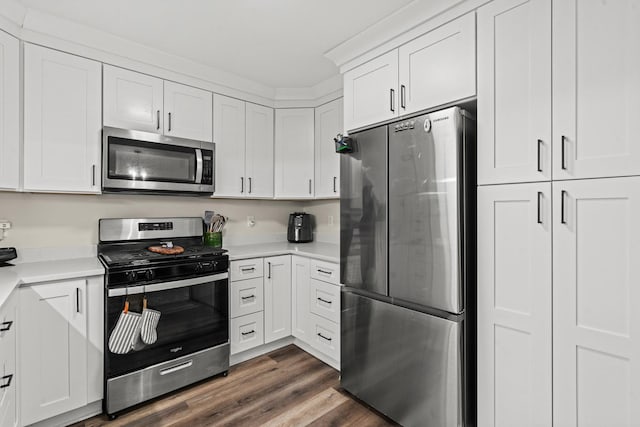 1598 Elder Dr, Aurora, IL 60506 - kitchen featuring appliances with stainless steel finishes, light countertops, white cabinets, and dark wood finished floors