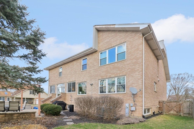 644 N Franklin Ave, Palatine, IL 60067 - rear view of property with brick siding, a gate, and stairway