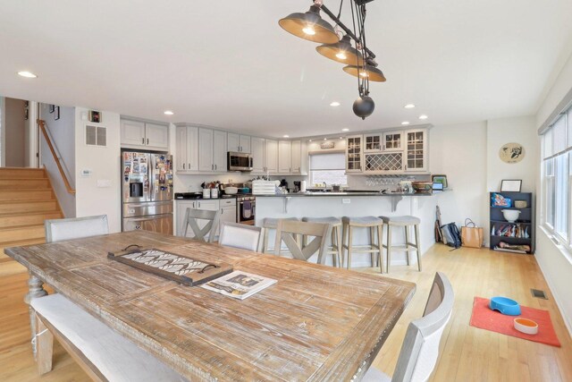 644 N Franklin Ave, Palatine, IL 60067 - dining room with recessed lighting, plenty of natural light, light wood finished floors, and stairway