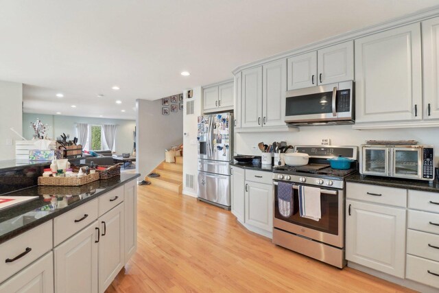 644 N Franklin Ave, Palatine, IL 60067 - kitchen with appliances with stainless steel finishes, light wood-type flooring, recessed lighting, dark stone counters, and open floor plan
