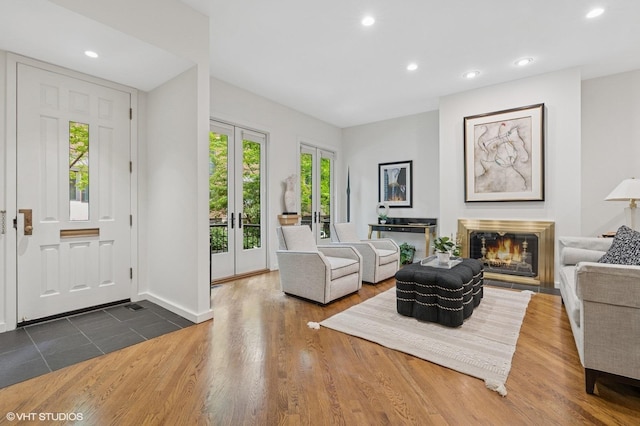 1327 N Sutton Pl, Chicago, IL 60610 - living room featuring recessed lighting, dark wood-type flooring, a lit fireplace, and french doors