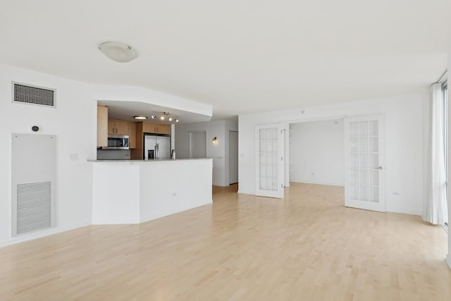 1640 Maple Ave Unit 1202, Evanston, IL 60201 - unfurnished living room featuring french doors and light wood finished floors
