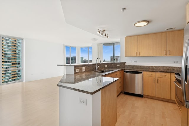 1640 Maple Ave Unit 1202, Evanston, IL 60201 - kitchen with stainless steel dishwasher, a peninsula, light wood finished floors, dark stone counters, and light brown cabinetry