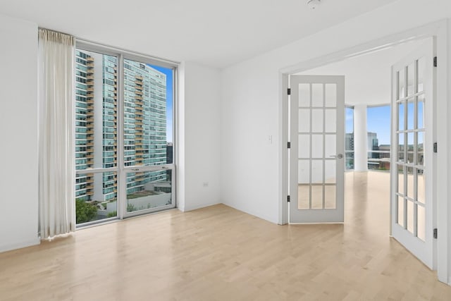 1640 Maple Ave Unit 1202, Evanston, IL 60201 - unfurnished room featuring expansive windows, wood finished floors, and french doors