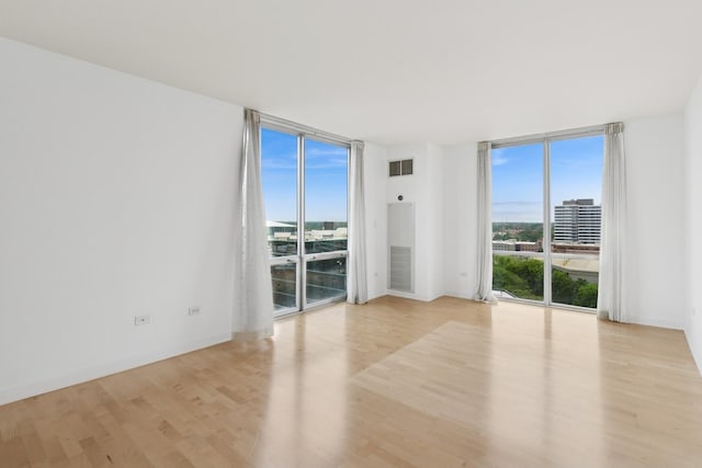 1640 Maple Ave Unit 1202, Evanston, IL 60201 - spare room featuring a wall of windows, plenty of natural light, and light wood finished floors