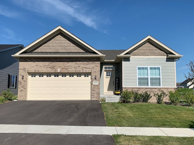 27410 W Porto Ln, Channahon, IL 60410 - view of front of home featuring brick siding, driveway, a front yard, and a garage