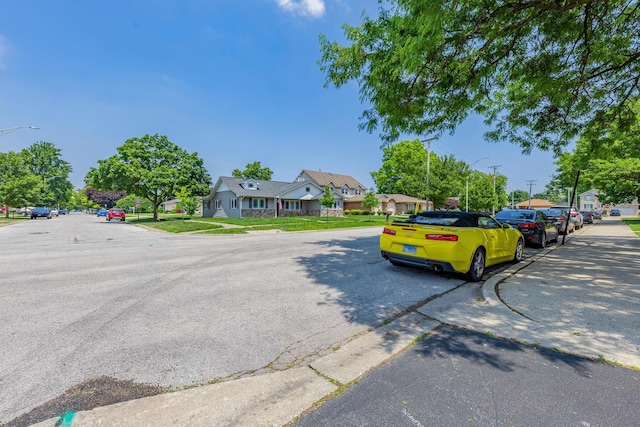 6135 W 94th St Unit A1, Oak Lawn, IL 60453 - view of asphalt street with street lights, sidewalks, and curbs