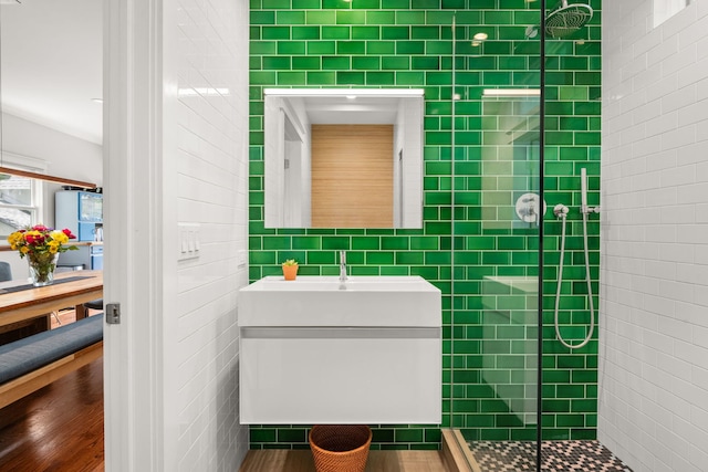 637 Highland Ave, Oak Park, IL 60304 - full bath featuring tile walls, a tile shower, vanity, and wood finished floors