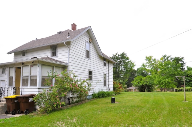 4816 Auburn St, Rockford, IL 61101 - view of home's exterior with a yard and a chimney
