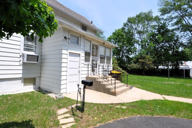 4816 Auburn St, Rockford, IL 61101 - view of home's exterior featuring a lawn, entry steps, and cooling unit