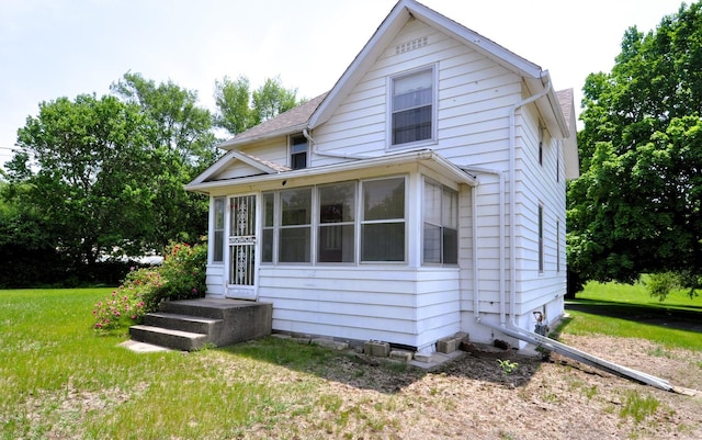 4816 Auburn St, Rockford, IL 61101 - view of front of house featuring a front lawn and a sunroom