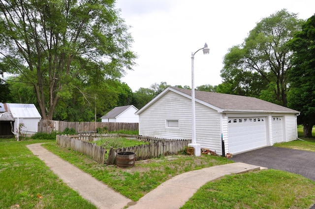 4816 Auburn St, Rockford, IL 61101 - view of home's exterior with a detached garage, an outbuilding, and a shingled roof
