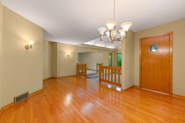 4303 Singleton Close, Rockford, IL 61114 - entrance foyer featuring light wood-type flooring, a textured ceiling, and a chandelier