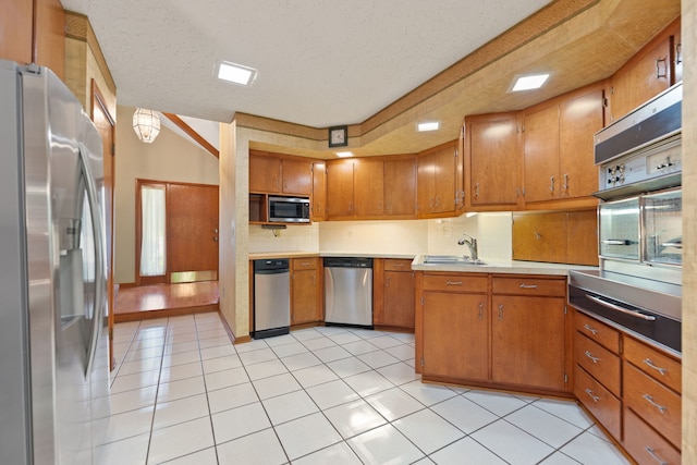 4303 Singleton Close, Rockford, IL 61114 - kitchen with stainless steel appliances, light countertops, a warming drawer, brown cabinetry, and light tile patterned floors