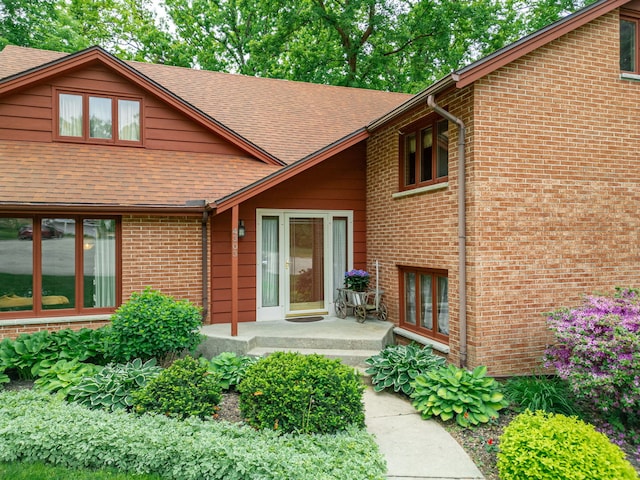 4303 Singleton Close, Rockford, IL 61114 - view of exterior entry featuring roof with shingles and brick siding