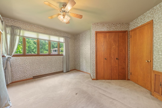 4303 Singleton Close, Rockford, IL 61114 - unfurnished bedroom featuring baseboard heating, wallpapered walls, light colored carpet, a closet, and ceiling fan
