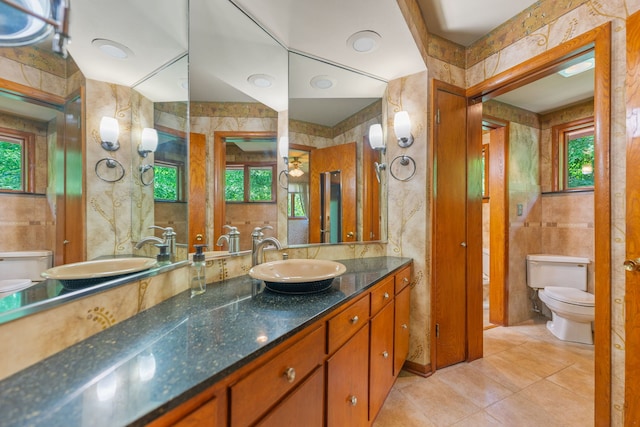 4303 Singleton Close, Rockford, IL 61114 - bathroom featuring tile walls, healthy amount of natural light, tile patterned floors, and vanity