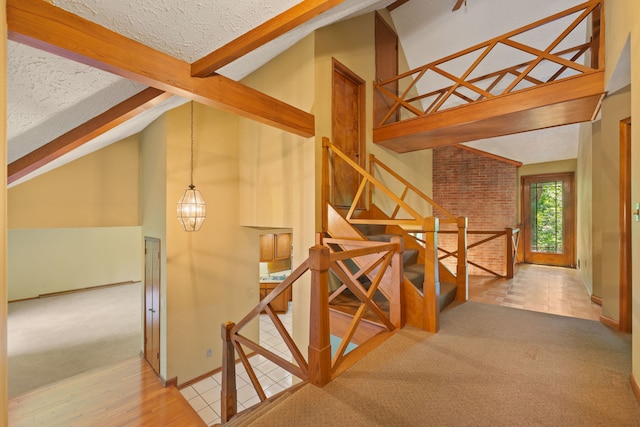4303 Singleton Close, Rockford, IL 61114 - stairway featuring beamed ceiling, carpet flooring, a textured ceiling, and high vaulted ceiling
