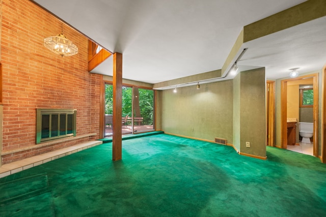 4303 Singleton Close, Rockford, IL 61114 - unfurnished living room with track lighting, carpet floors, and a brick fireplace