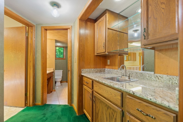 4303 Singleton Close, Rockford, IL 61114 - kitchen with light tile patterned floors, brown cabinets, and light stone counters