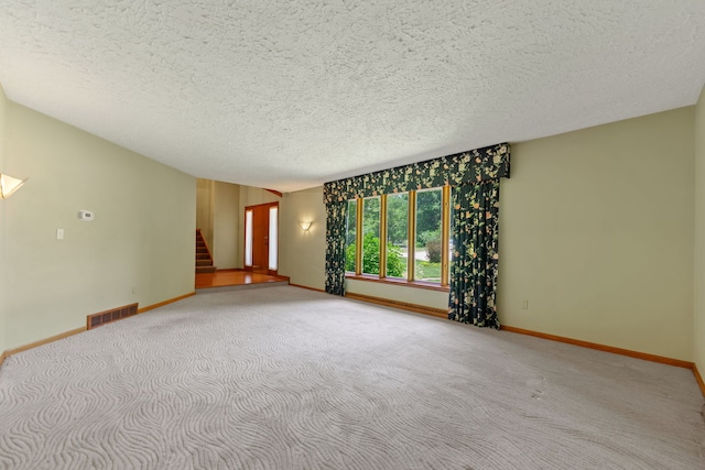 4303 Singleton Close, Rockford, IL 61114 - carpeted spare room with a textured ceiling and stairway