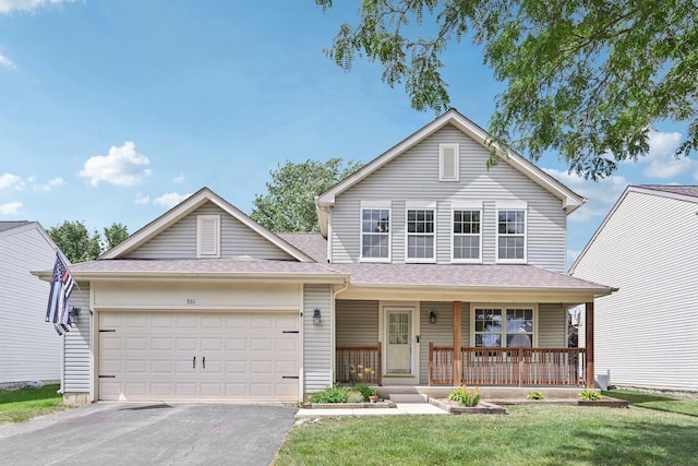 561 Ryegrass Trl, Aurora, IL 60504 - traditional home featuring a garage, a porch, asphalt driveway, a shingled roof, and a front yard