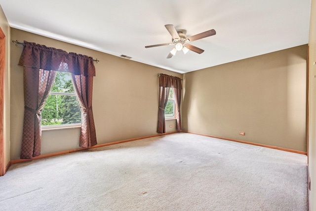 561 Ryegrass Trl, Aurora, IL 60504 - spare room featuring healthy amount of natural light, carpet flooring, and a ceiling fan