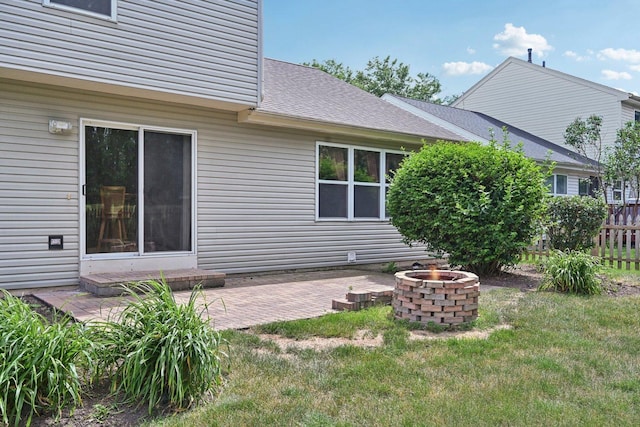 561 Ryegrass Trl, Aurora, IL 60504 - rear view of property featuring an outdoor fire pit, a patio, and roof with shingles